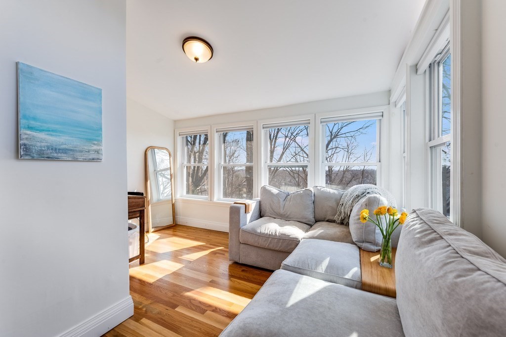 21 Arborough Road Boston, MA 02131 - Photo 15 of 40 a living room with furniture and a floor to ceiling window