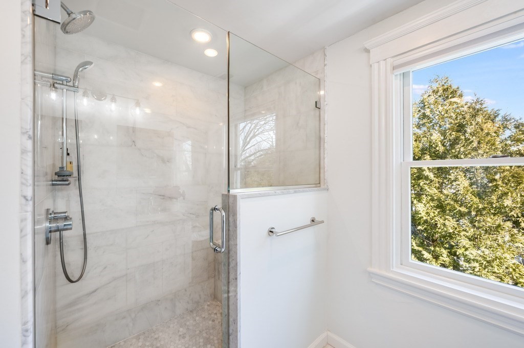 21 Arborough Road Boston, MA 02131 - Photo 18 of 40 a bathroom with a glass shower door