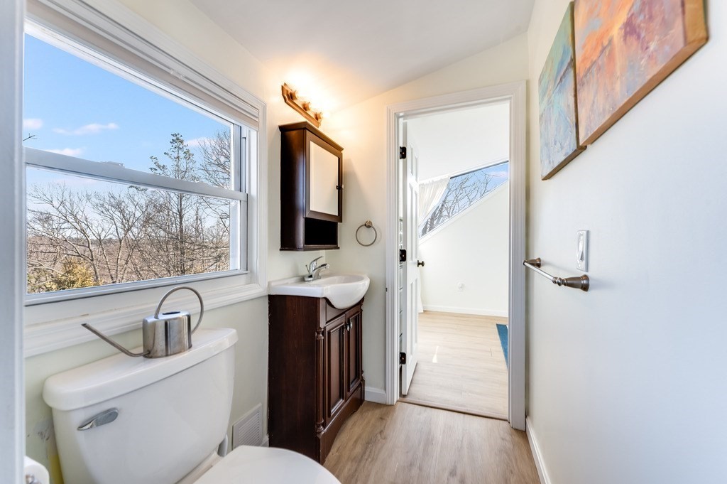 21 Arborough Road Boston, MA 02131 - Photo 24 of 40 a view of bathroom with a toilet a sink and a mirror