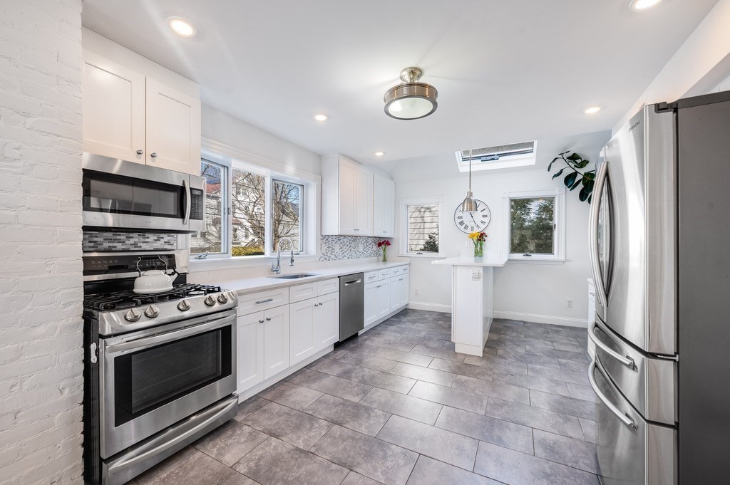 21 Arborough Road Boston, MA 02131 - Photo 7 of 40 a kitchen with a stove refrigerator and a sink
