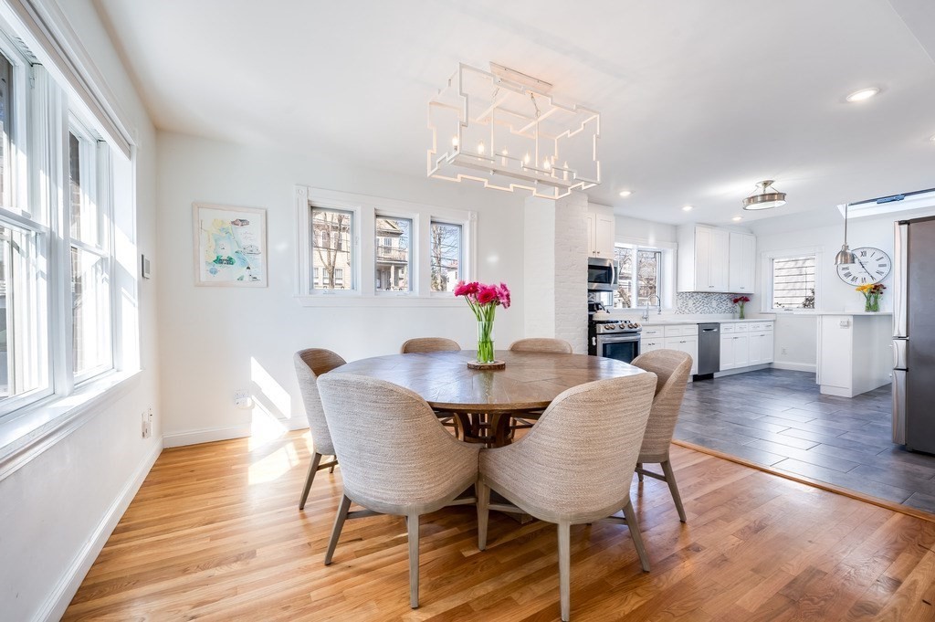 21 Arborough Road Boston, MA 02131 - Photo 9 of 40 a view of a dining room with furniture a chandelier and wooden floor