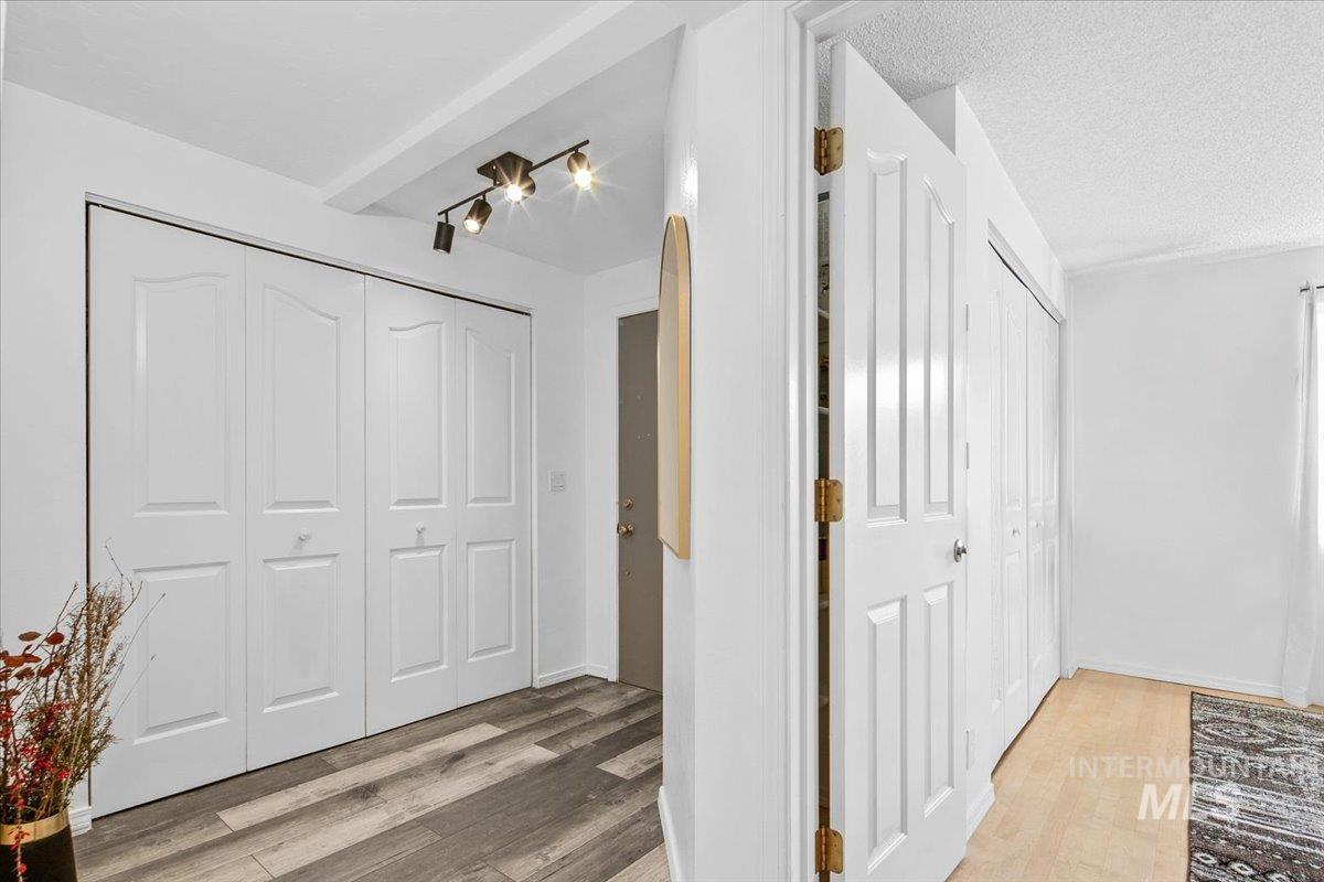 3651 South Gekeler Lane, Unit 96 Boise, ID 83706 - Photo 12 of 38 Hall featuring light wood-style floors and a textured ceiling