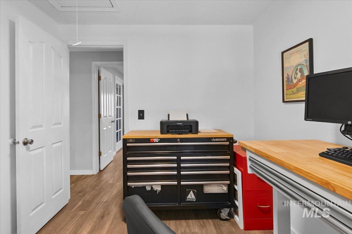 3651 South Gekeler Lane, Unit 96 Boise, ID 83706 - Photo 24 of 38 Home office with attic access, dark wood finished floors, and a textured ceiling