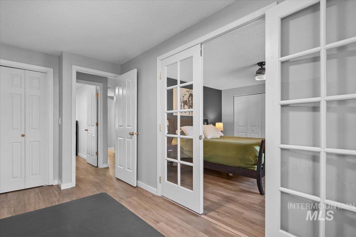 3651 South Gekeler Lane, Unit 96 Boise, ID 83706 - Photo 25 of 38 Home office with a textured ceiling, light wood-type flooring, and french doors