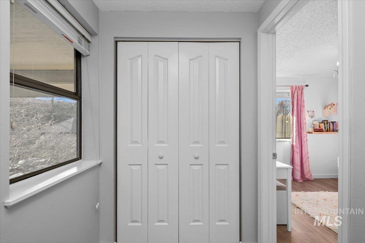 3651 South Gekeler Lane, Unit 96 Boise, ID 83706 - Photo 27 of 38 Hall featuring wood finished floors and a textured ceiling