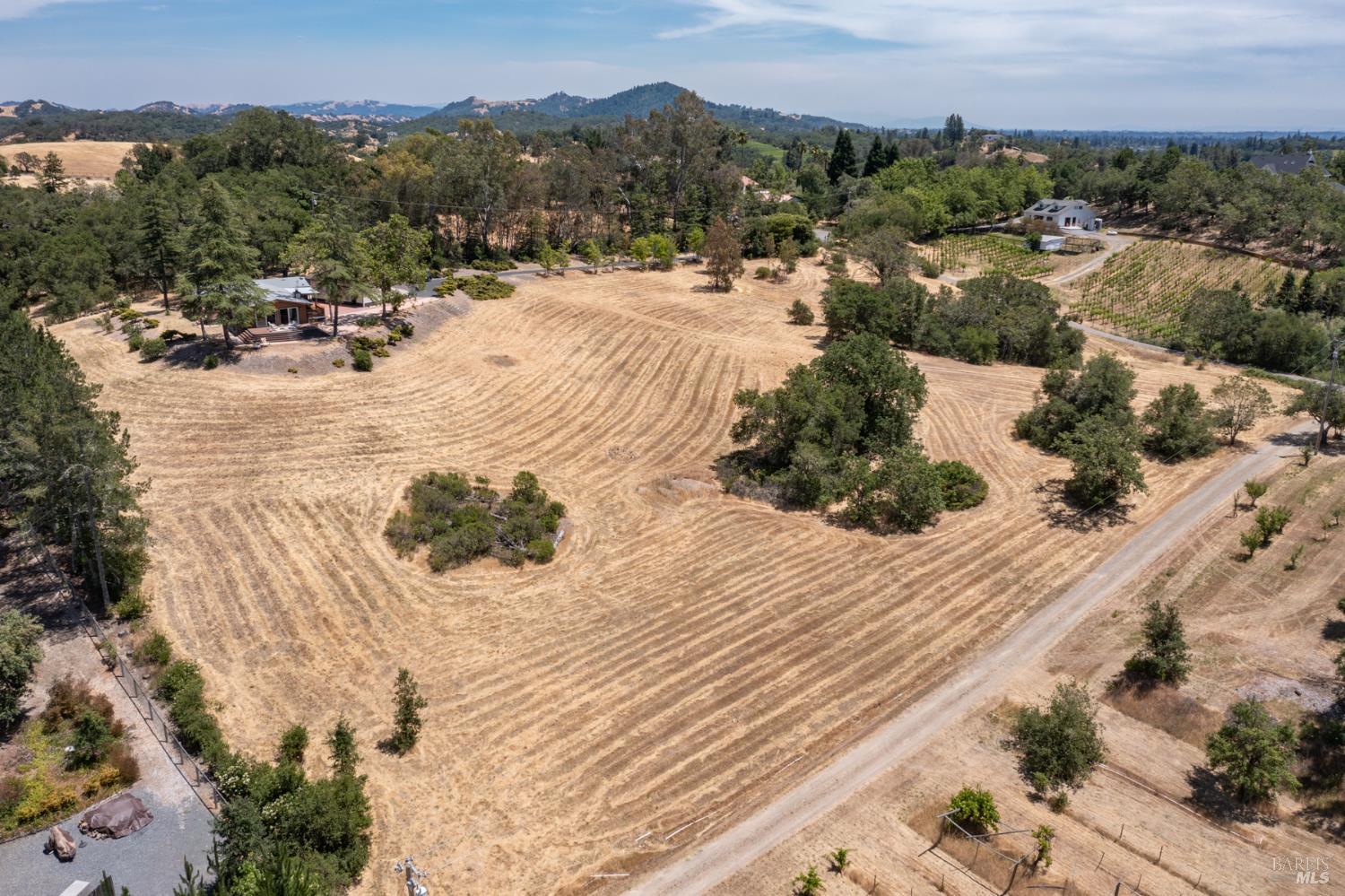 1676 Chiquita Road Healdsburg, CA 95448 - Photo 4 of 46 Nestled up on the top of the knoll, this home sits on 5.29 usable acres and takes in sweeping views of the surrounding valleys and mountains.