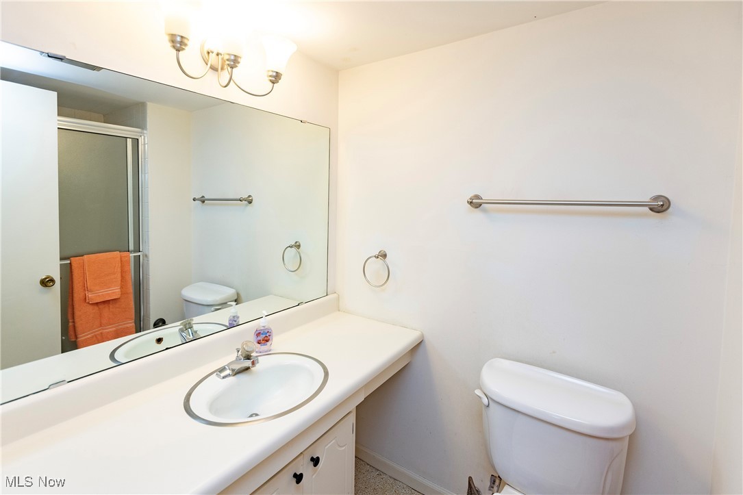 22701 Center Ridge Road, Unit 307 Rocky River, OH 44116 - Photo 21 of 27 Full bath with vanity, a stall shower, and a chandelier