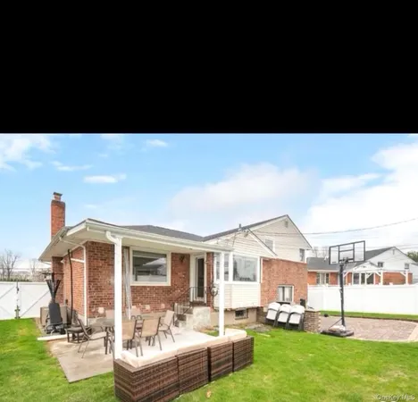 a front view of a house with a yard table and chairs