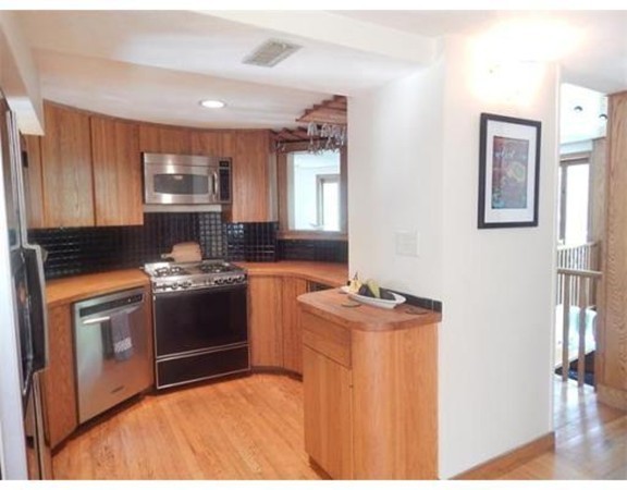 112 Trapelo Road Lincoln, MA 01773 - Photo 18 of 19 a kitchen with stainless steel appliances granite countertop a stove a sink and a microwave