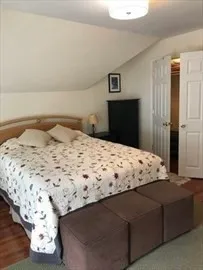 a bedroom with a bed and a night stand