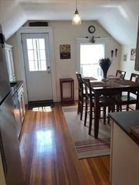 a view of a dining room with furniture and window