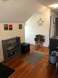 a living room with furniture and a piano