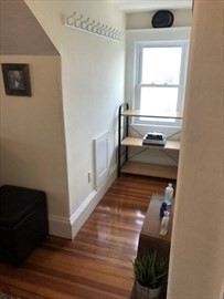 3 Guernsey Street, Unit 3 Boston, MA 02131 - Photo 8 of 23 a view of a hallway with wooden floor and staircase