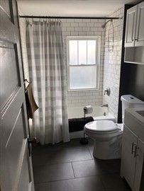 3 Guernsey Street, Unit 3 Boston, MA 02131 - Photo 9 of 23 a bathroom with a sink and a toilet