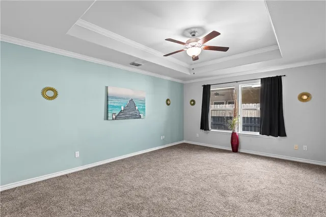a view of a livingroom with a ceiling fan and window