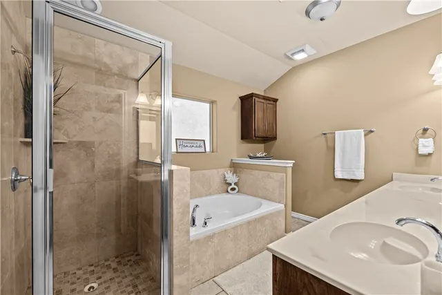 a bathroom with a tub sink and mirror