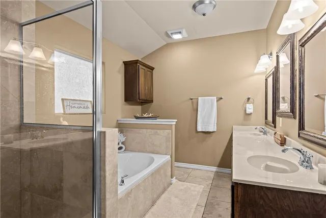 a bathroom with a tub sink and mirror