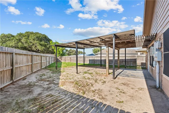 a white house with a big yard and wooden fence