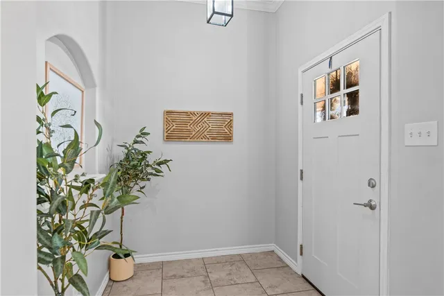 a vase with flowers sitting on a floor