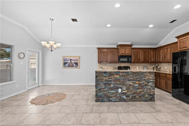 a large kitchen with cabinets and stainless steel appliances