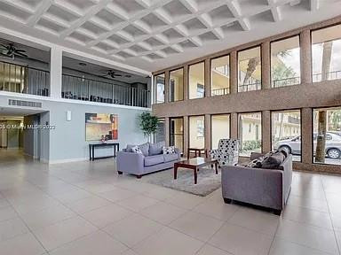 9440 Southwest 8th Street, Unit 202 Boca Raton, FL 33428 - Photo 3 of 20 a living room with furniture and a large window