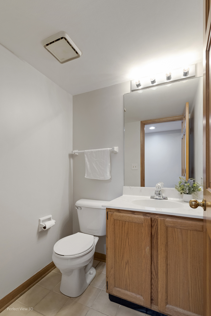 970 Amberwood Circle Naperville, IL 60563 - Photo 12 of 26 a bathroom with a granite countertop sink mirror vanity and toilet