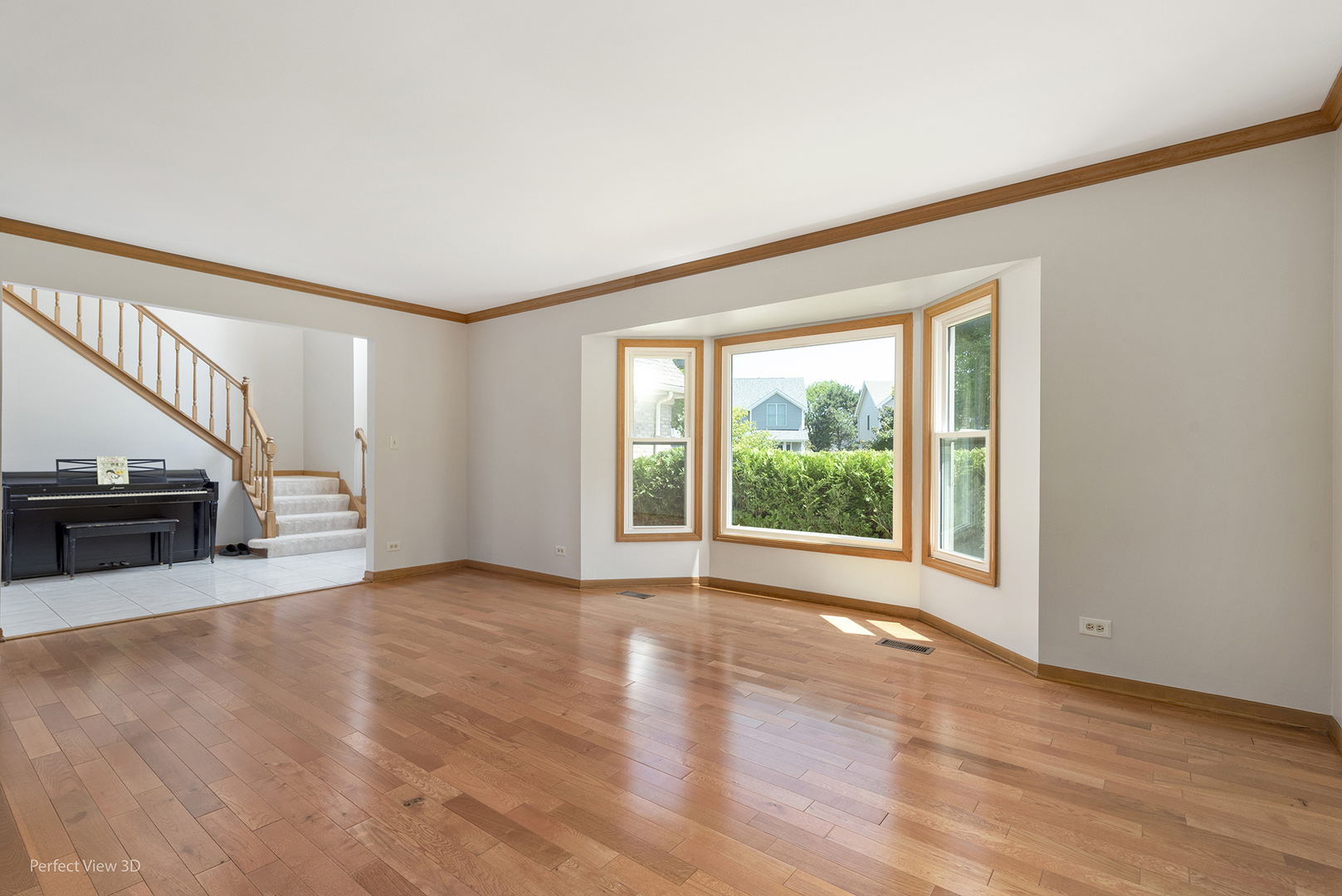 970 Amberwood Circle Naperville, IL 60563 - Photo 3 of 26 a view of an empty room with wooden floor and a window