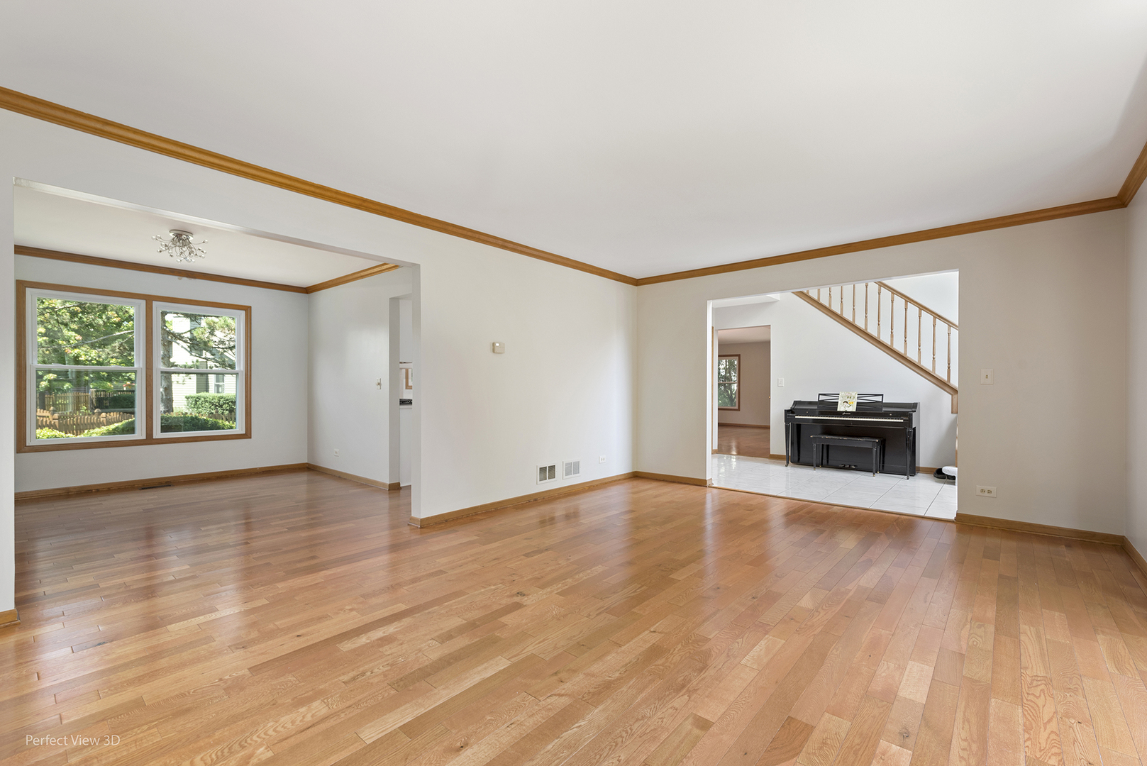 970 Amberwood Circle Naperville, IL 60563 - Photo 4 of 26 a view of an empty room with wooden floor a ceiling fan and windows