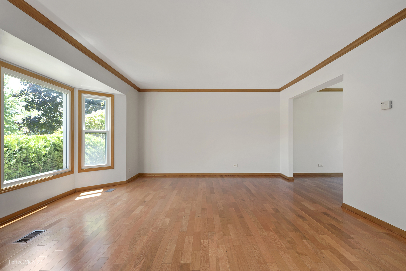 970 Amberwood Circle Naperville, IL 60563 - Photo 5 of 26 a view of an empty room with wooden floor and a window