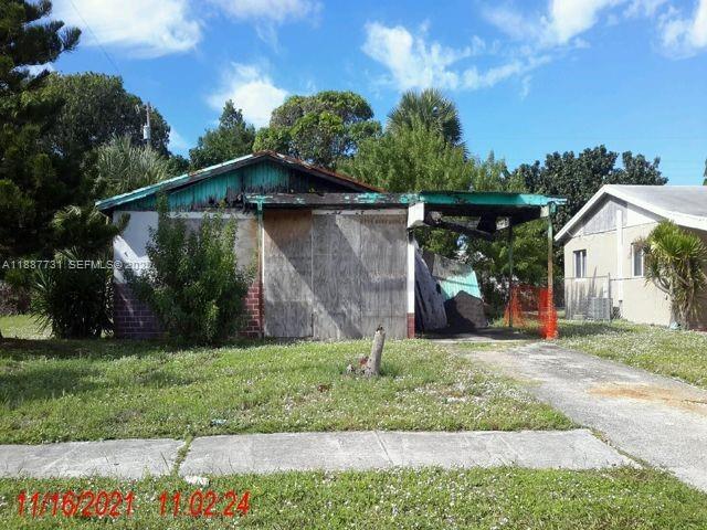 a view of a wooden house with a yard