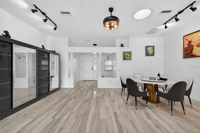 a view of a dining room with furniture and wooden floor