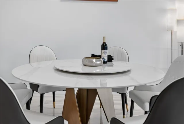 a close view of dining table chairs and appliances