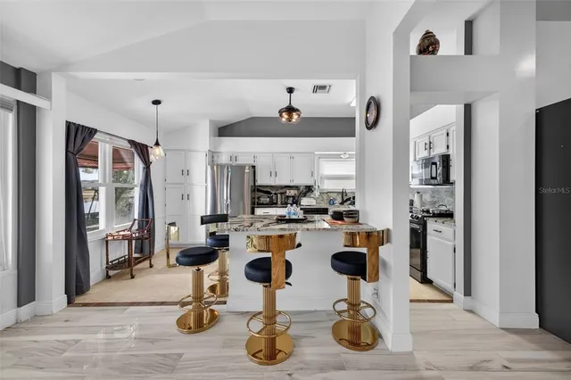 a view of a kitchen with dining table and chairs