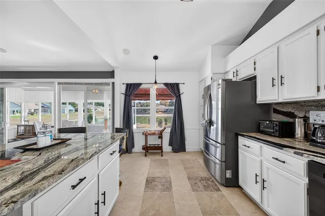 a kitchen with stainless steel appliances a refrigerator sink and stove