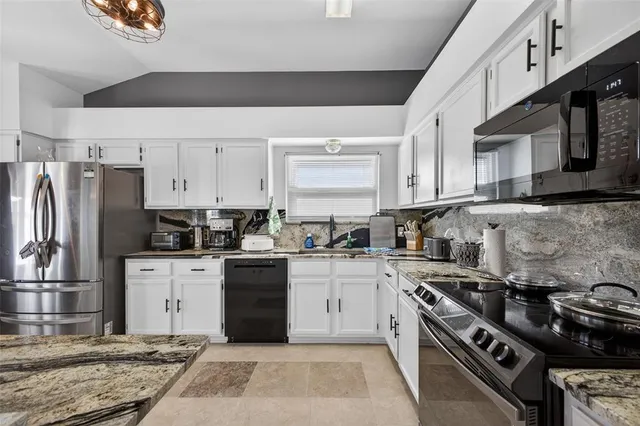a kitchen with a stove sink and refrigerator