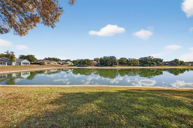 a view of a lake with houses in the background