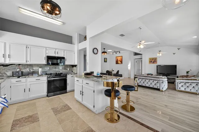 a kitchen with white cabinets and appliances