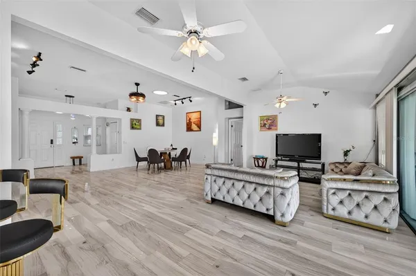 a living room with furniture and wooden floor