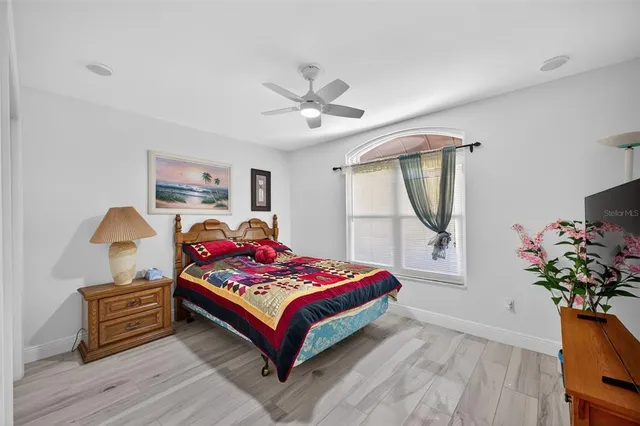 a bedroom with a bed a dresser and window