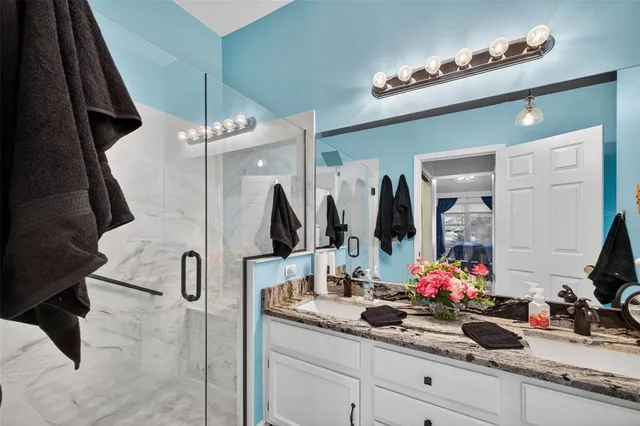 a bathroom with a double vanity sink and a mirror