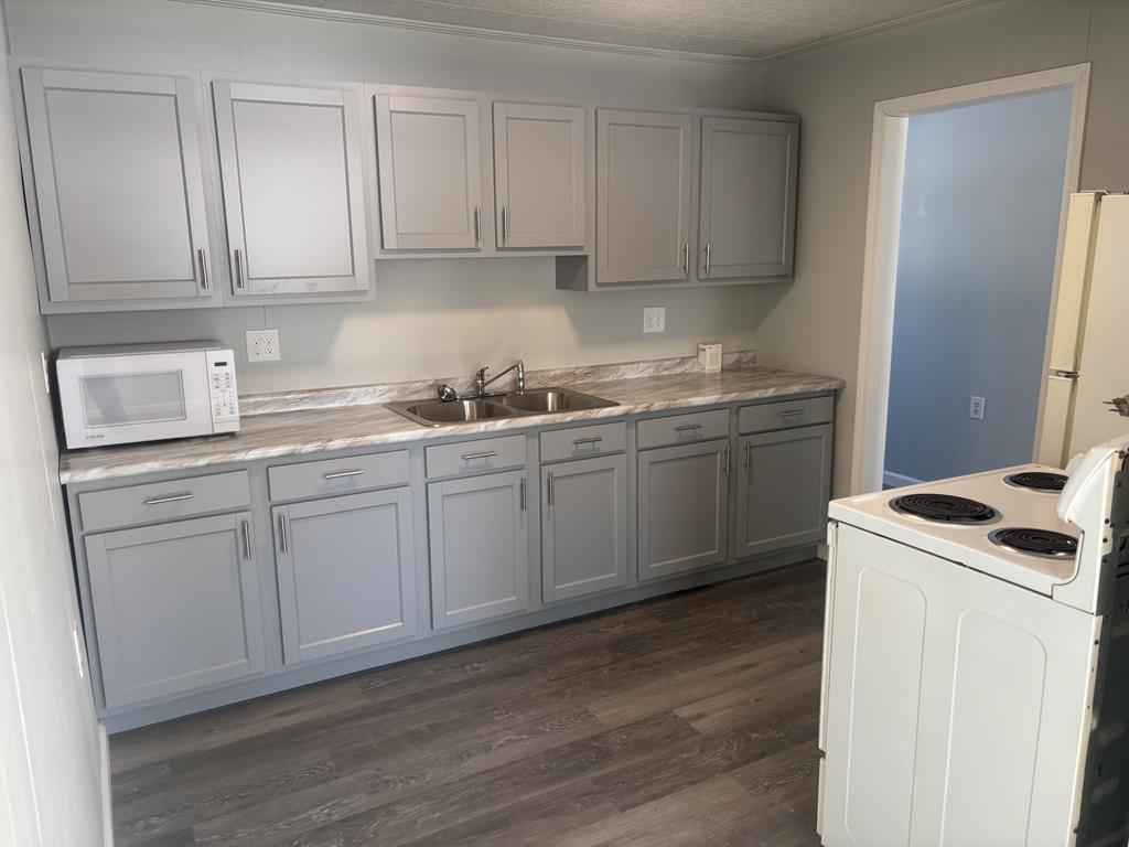 1369 Lawsonham Road, Unit 2 Rimersburg, PA 16248 - Photo 3 of 10 a kitchen with stainless steel appliances granite countertop a sink stove and cabinets