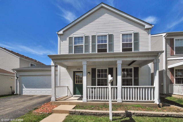 1734 Windcrest Lane Aurora, IL 60504 - Photo 1 of 10 a front view of a house with a yard
