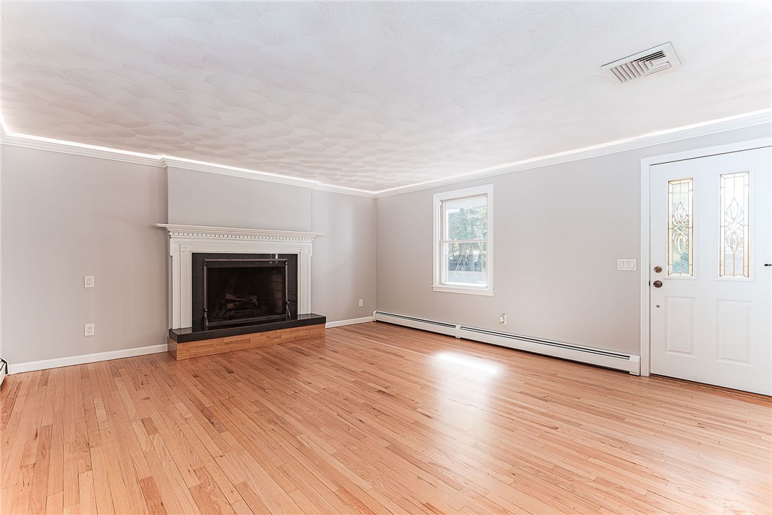 680 Fletcher Road North Kingstown, RI 02852 - Photo 13 of 41 Enter from side porch door into spacious family room with fireplace and accent lighting.