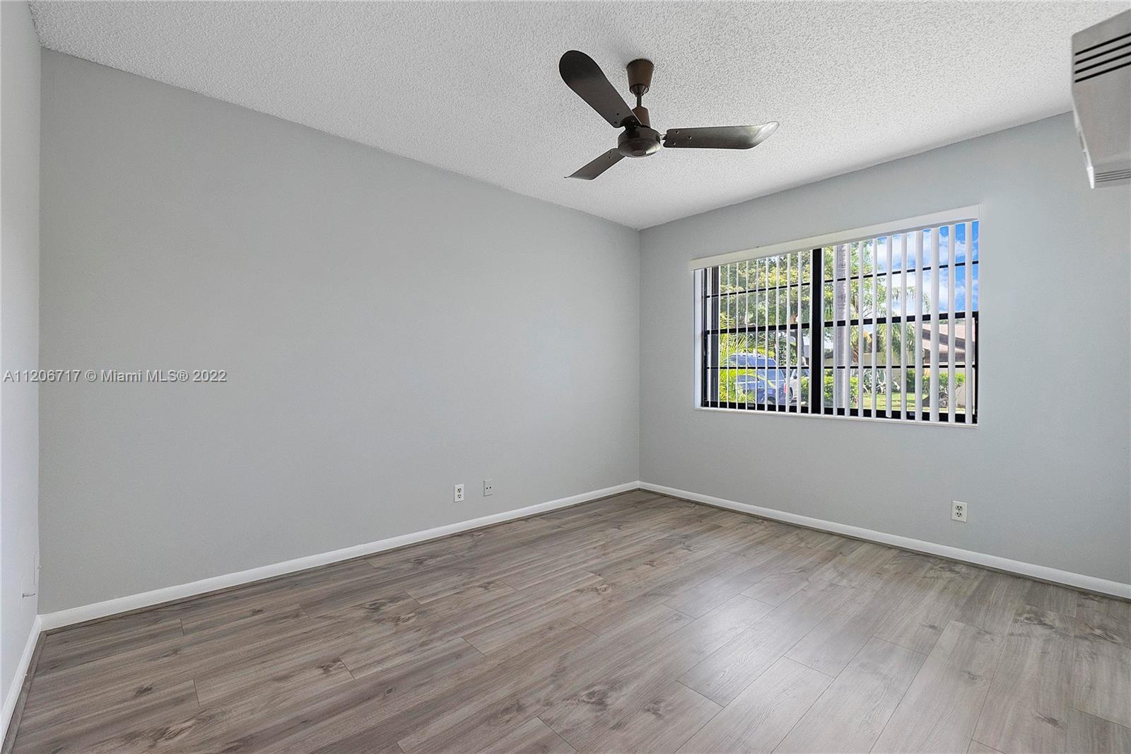 633 Banks Road, Unit 633 Margate, FL 33063 - Photo 23 of 48 wooden floor in an empty room with a window