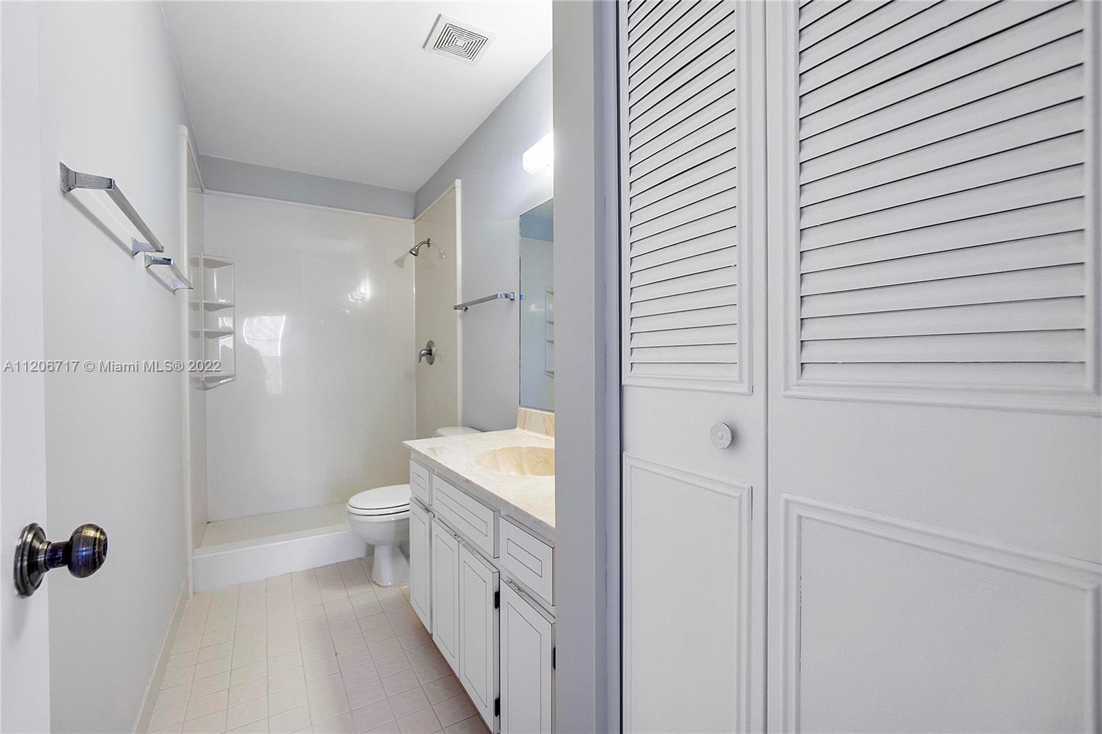 633 Banks Road, Unit 633 Margate, FL 33063 - Photo 25 of 48 a bathroom with a double vanity sink toilet and shower