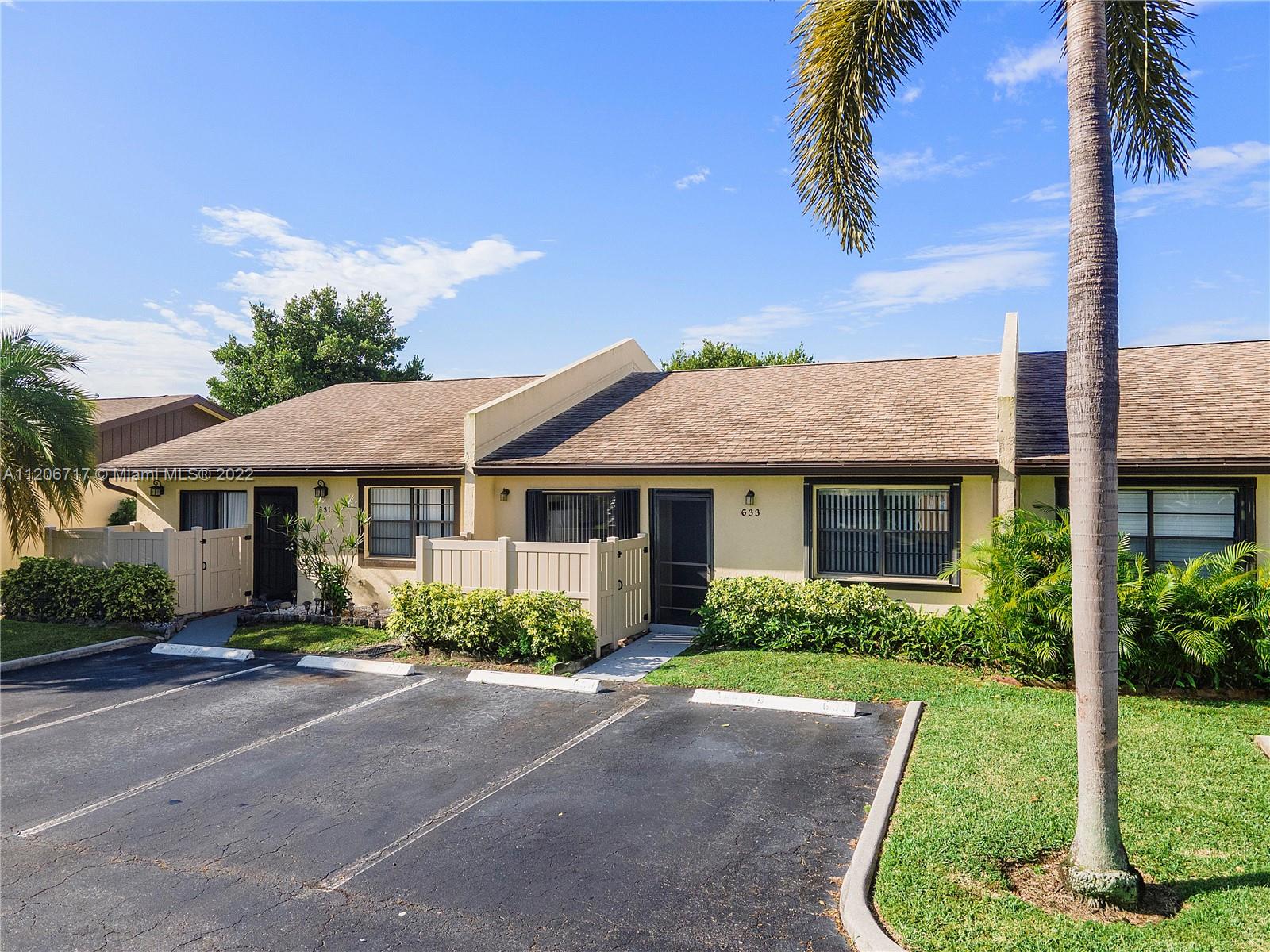 633 Banks Road, Unit 633 Margate, FL 33063 - Photo 46 of 48 a front view of a house with a garden
