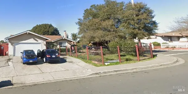 a view of a house with cars park