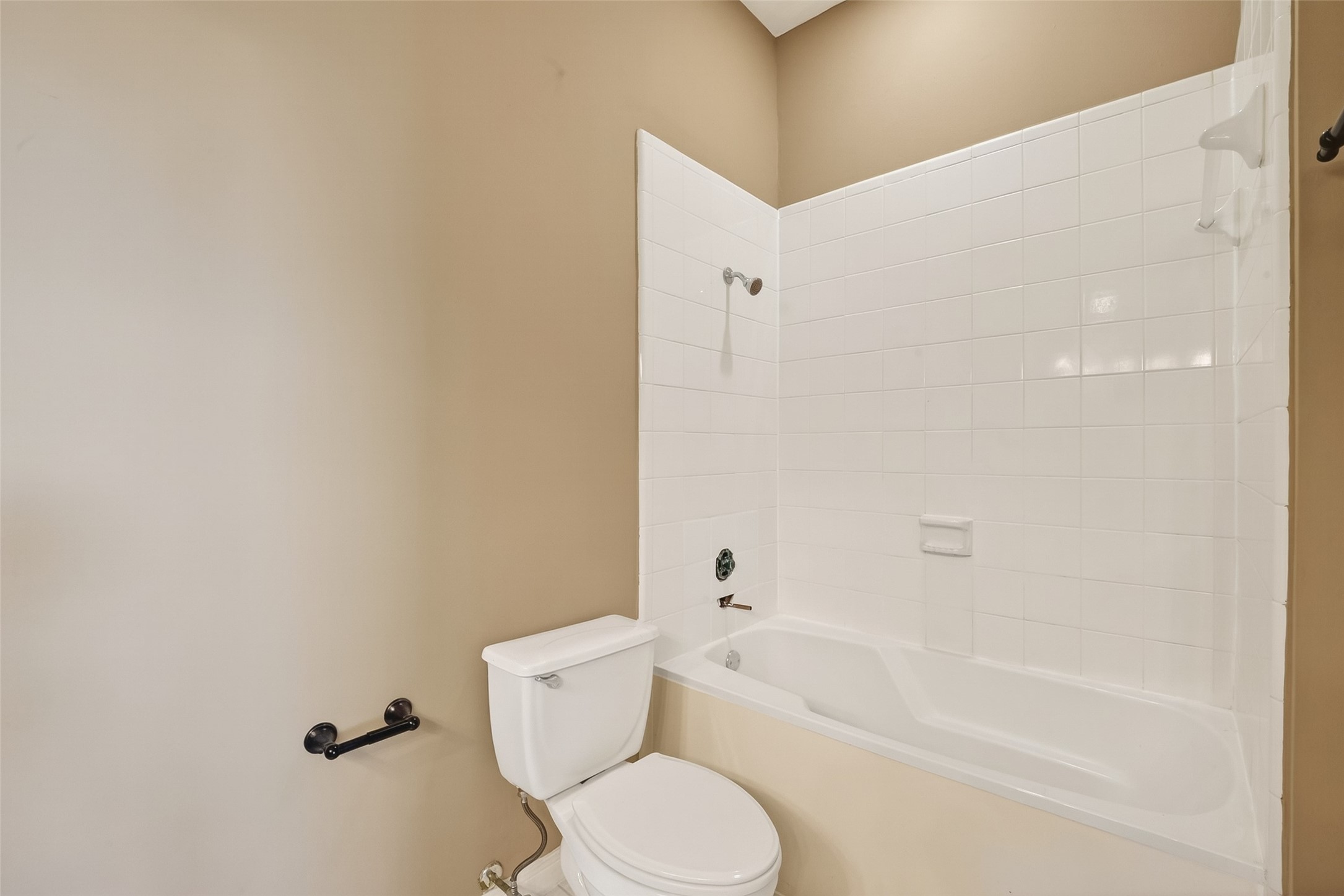 2804 Chenevert Street Houston, TX 77004 - Photo 31 of 37 a white toilet and tub sitting next to a white cabinet