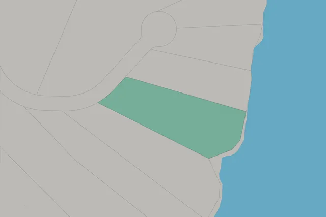 an aerial view of a house with a yard and lake view