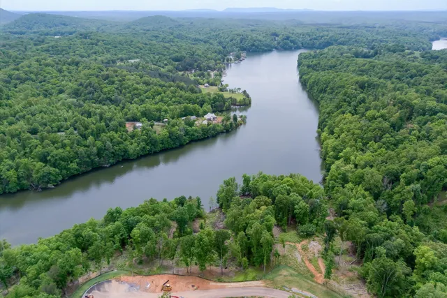 an aerial view of a house with outdoor space and lake view